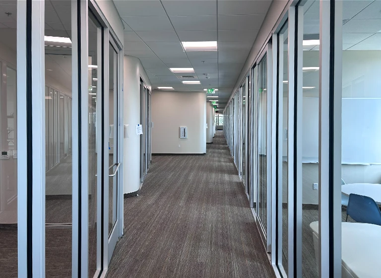 Open office layout with interior sliding glass door system at ESRI San Antonio